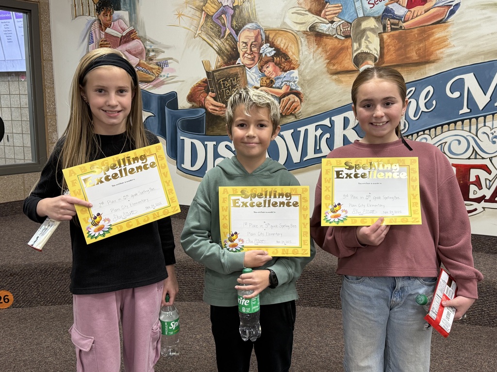 three students who have won the spelling bee standing in a line with certificates that say "spelling excellence"