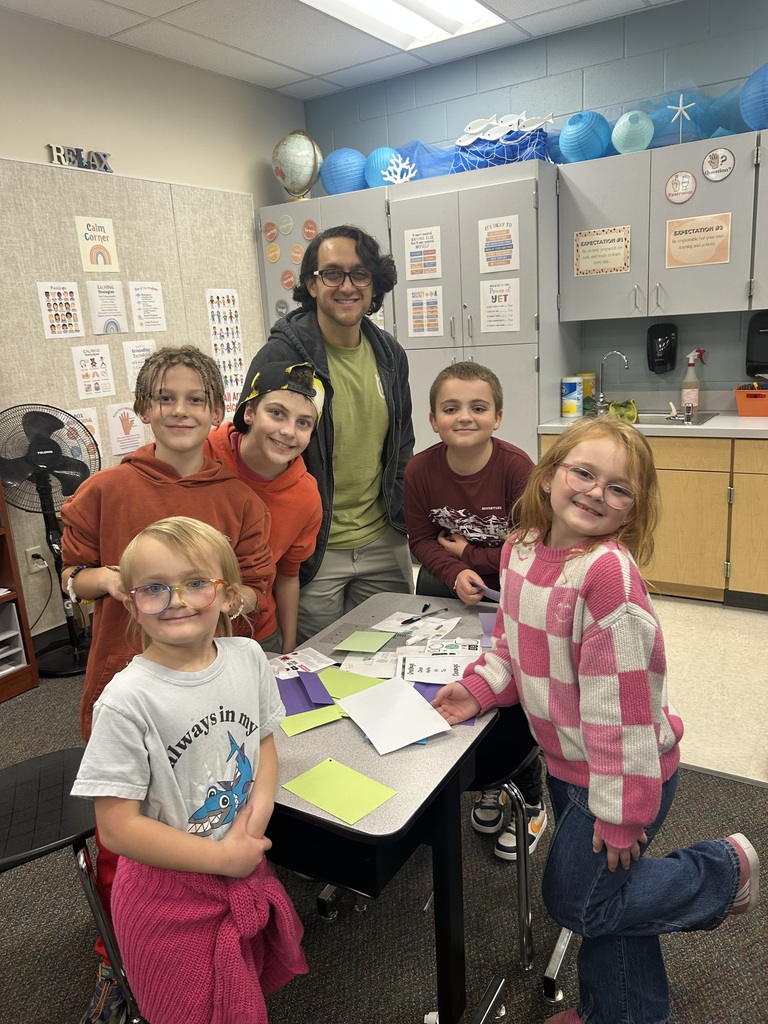Families writing kindness notes.
