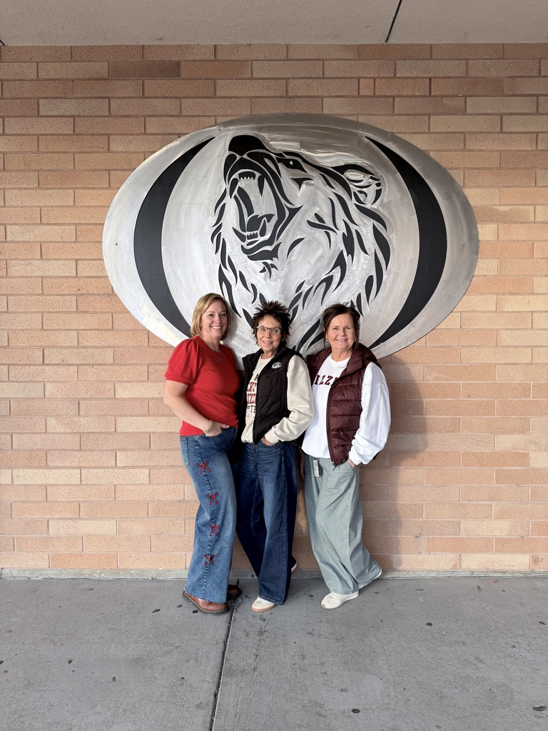 picture of three people in front of a building
