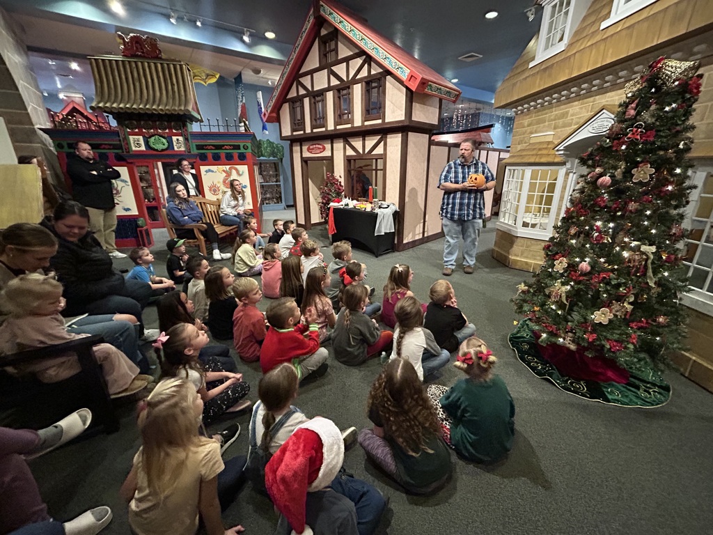 group of students sitting and looking at the teacher