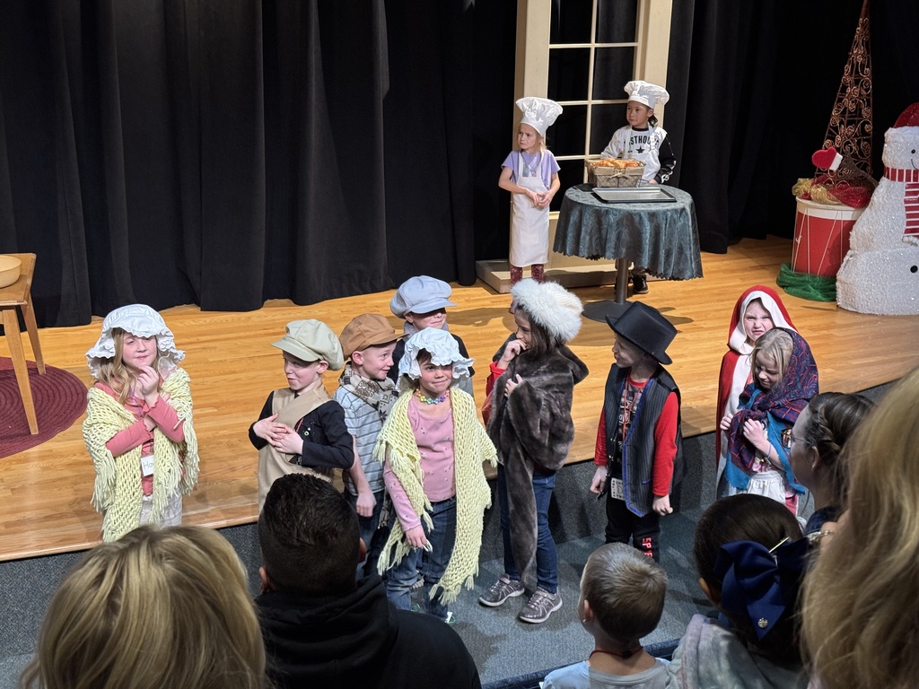 group of students wearing costumes on a stage