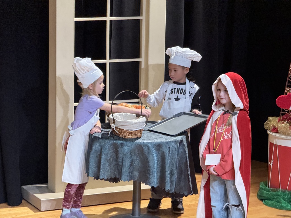 group of students with baker hates and one with a red cloak on 