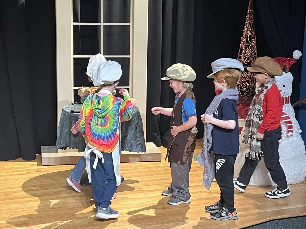 Students act out a play in costumes