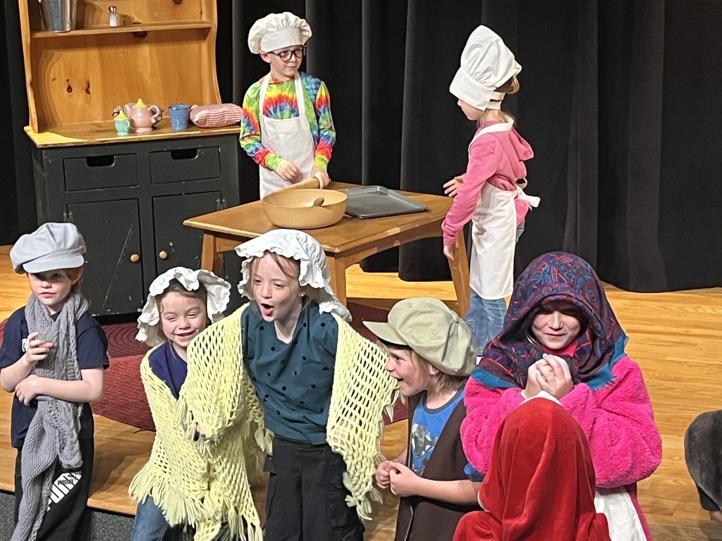 Students act out a play in costumes
