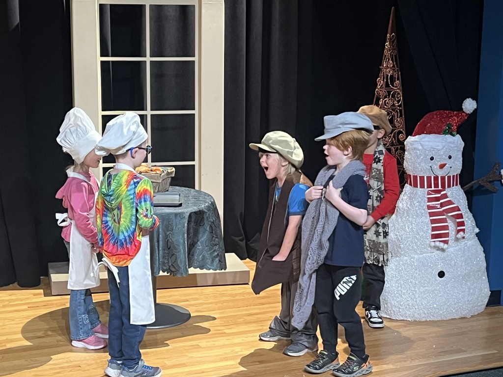 Students act out a play in costumes