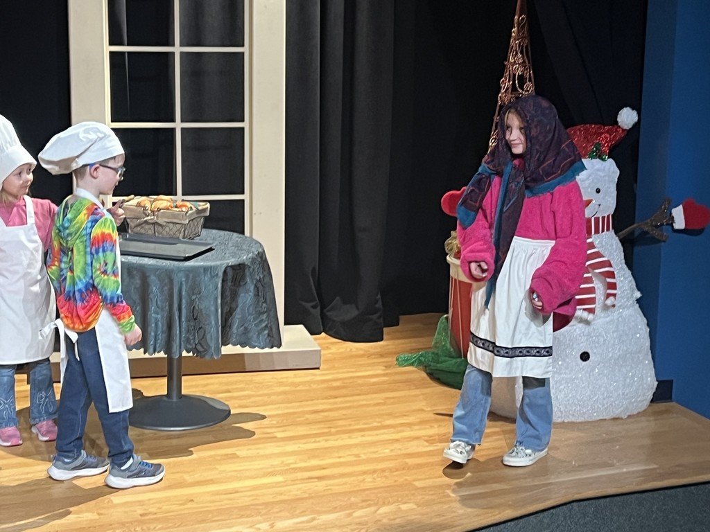 Students act out a play in costumes