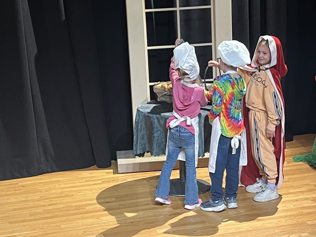 Students act out a play in costumes