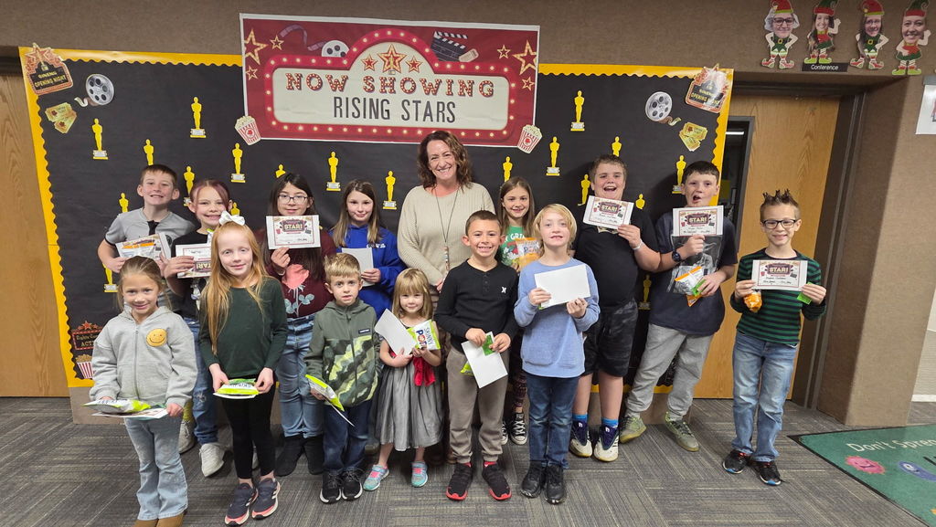 Students and Principal posing for camera with awards