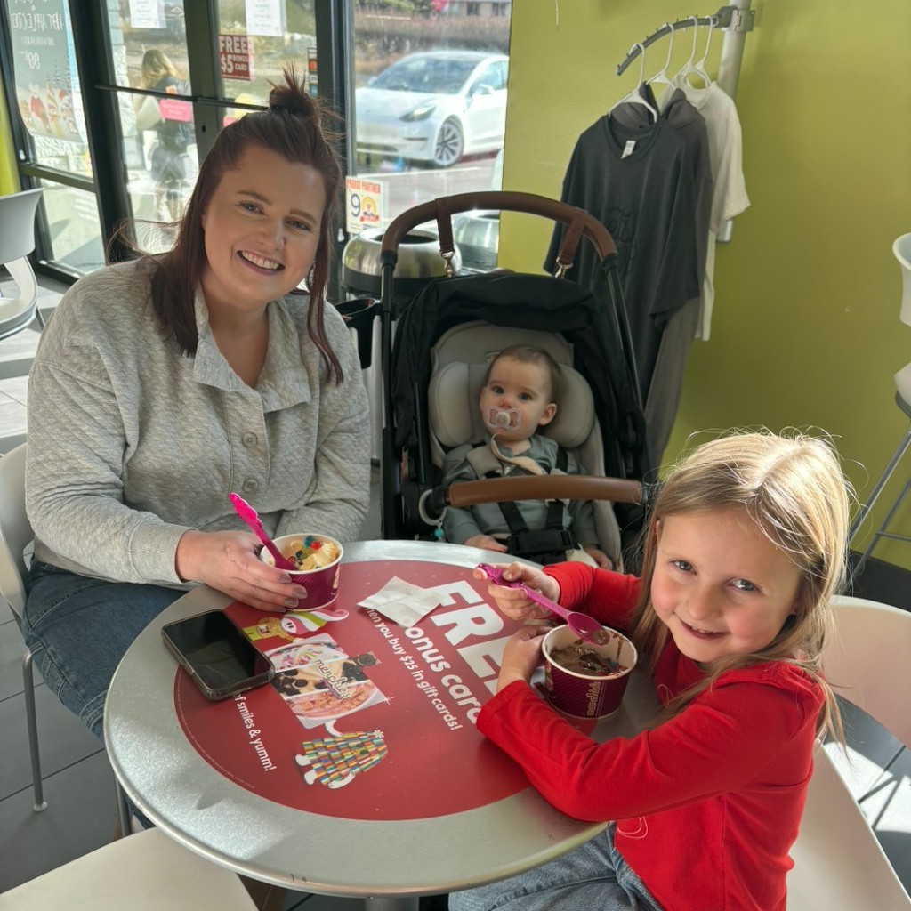 A mom and her two kids eating ice cream at Menchies