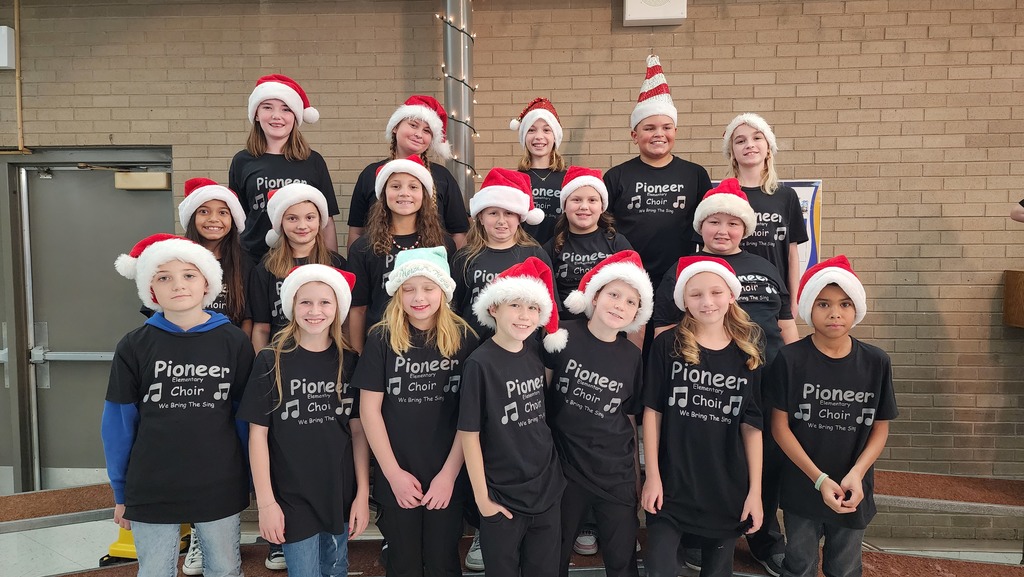 choir students with santa hats posing for camera
