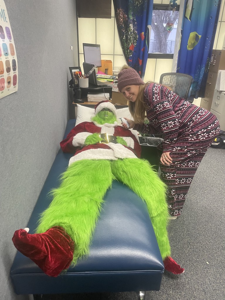 The Grinch having his heart checked by Nurse Meghan