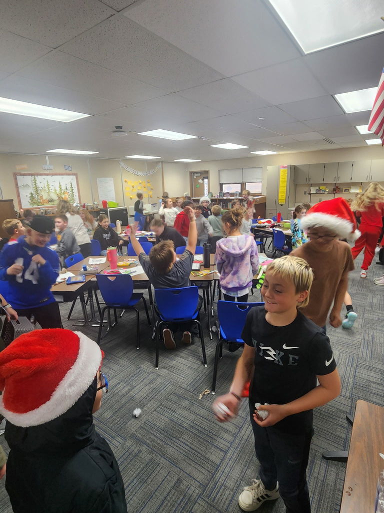 5th and 2nd graders throwing snowballs in a classroom.
