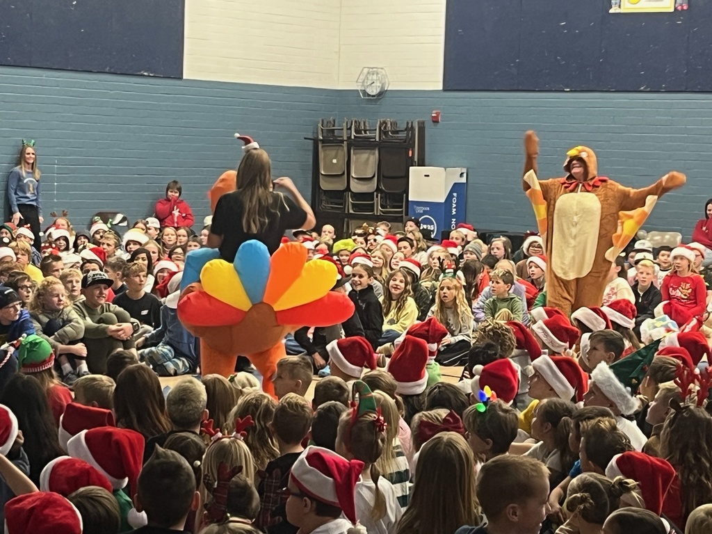 Farr West Sing along in the gym with two second grade teachers in turkey costumes