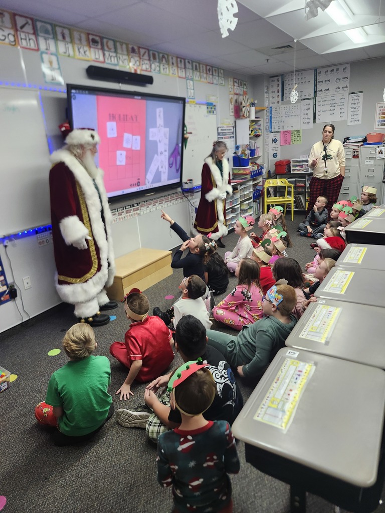 Students listening to Santa and Mrs. Claus