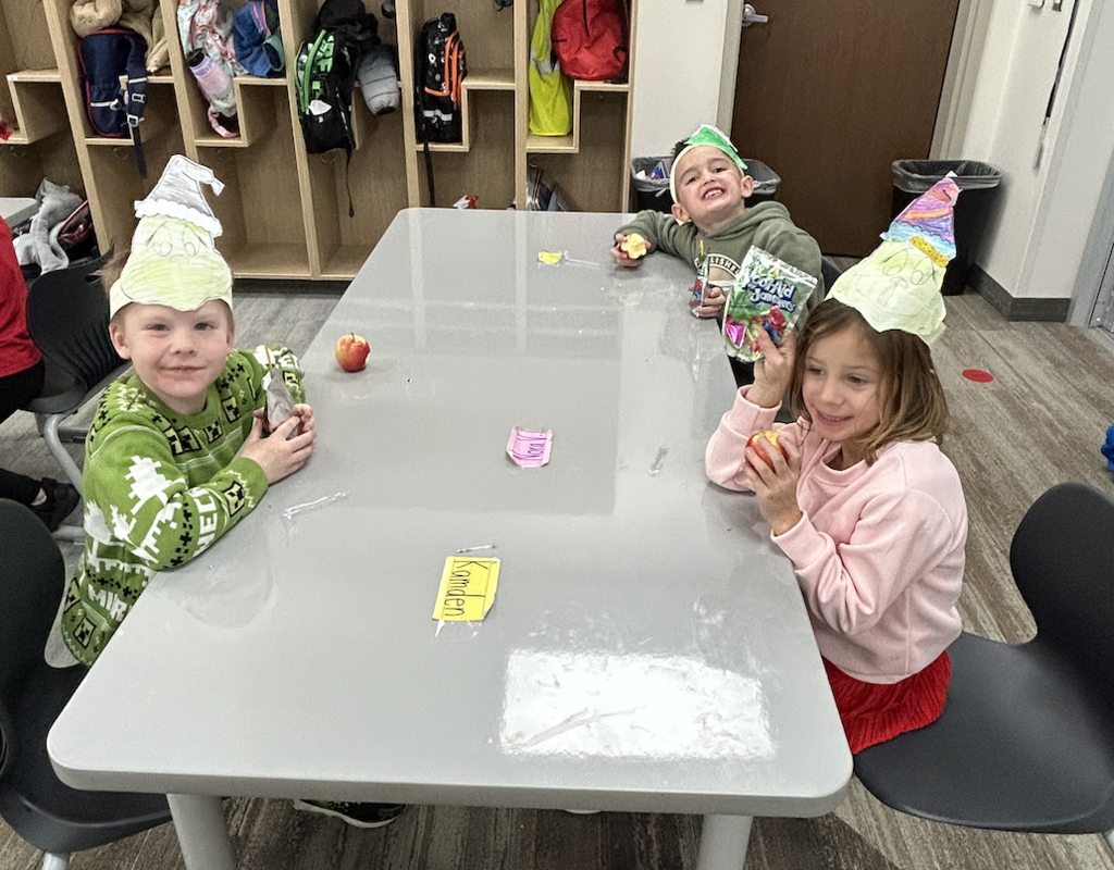 students celebrating grinch day with student made grinch hats