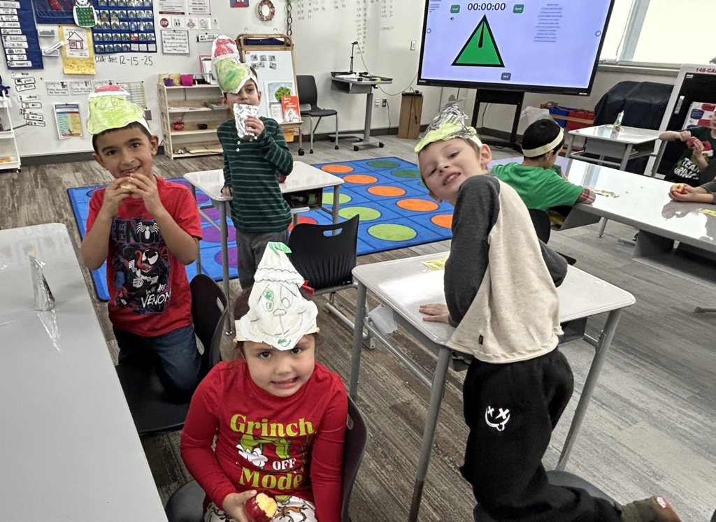 students celebrating grinch day with student made grinch hats