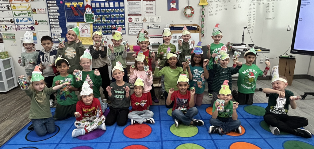 students celebrating grinch day with student made grinch hats