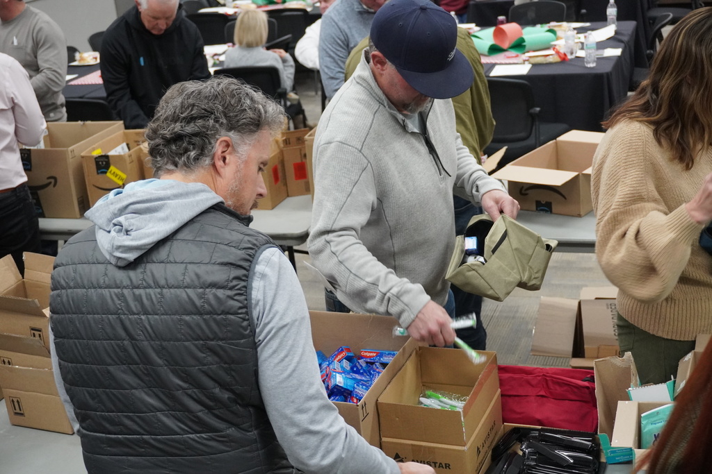 Board members came together to assemble hygiene kits that will be available at teen centers for students in need.