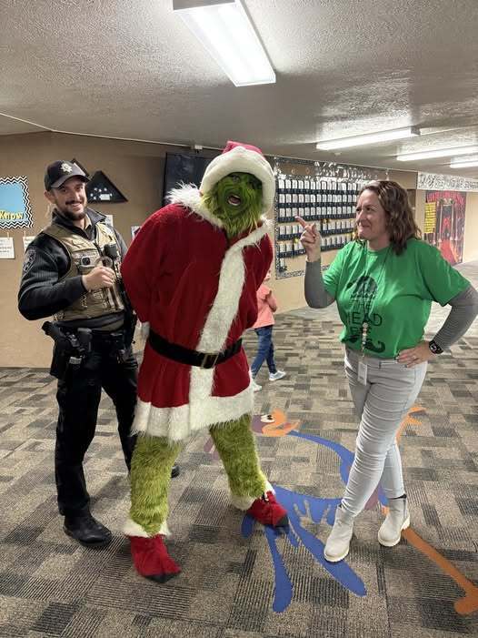 Grinch being handcuffed.