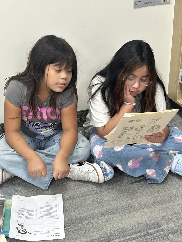 two 4th grade students reading together