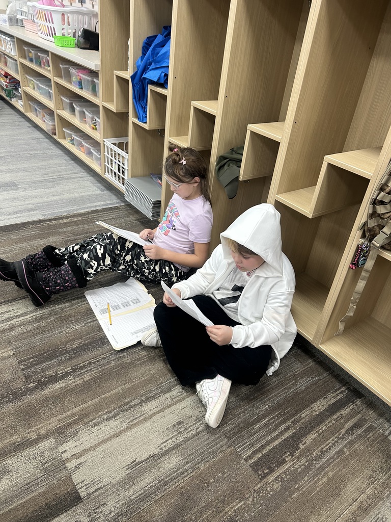 two 4th grade students reading together