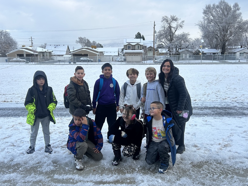 4th grade students and teacher playing in the snow