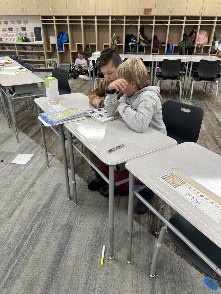 two 4th grade students reading together
