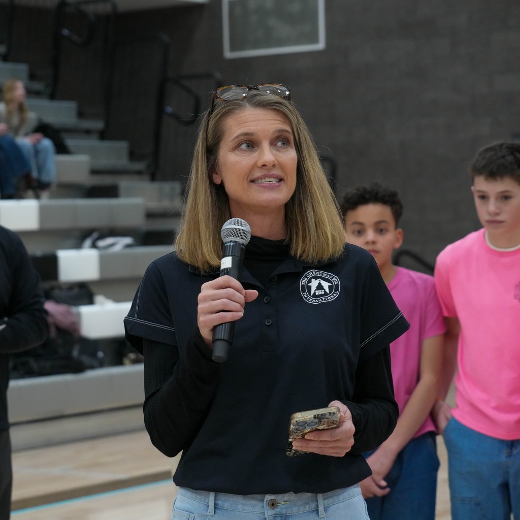 Christmas box house student donations half time presentation presenter.