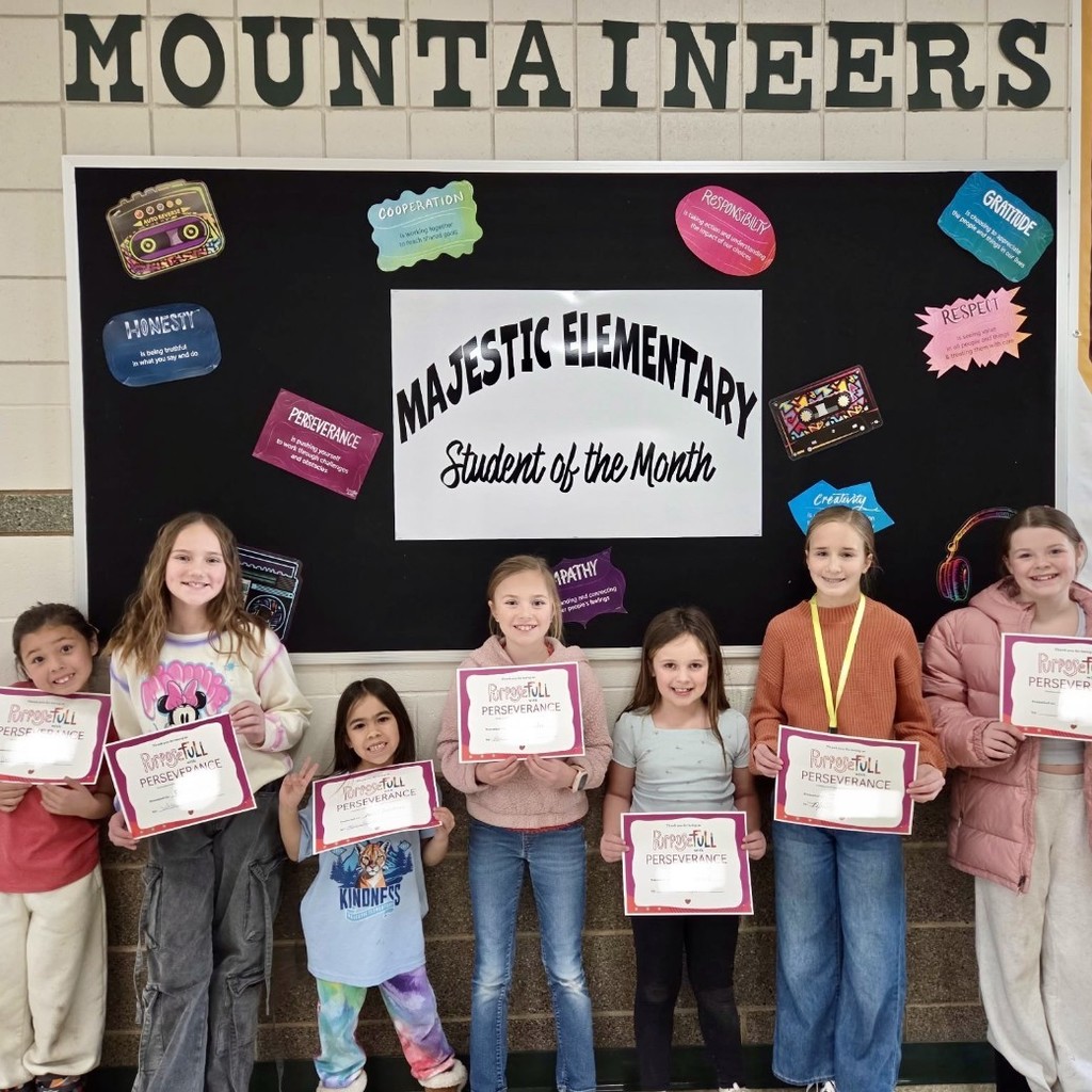 Kids holding certificates for student of the month.