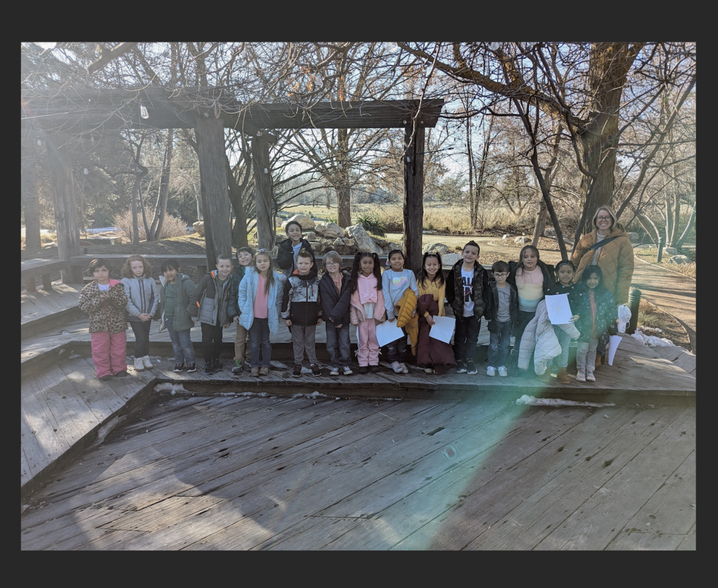 first grade class posing outside at the nature center