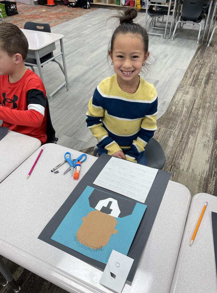 student showing their art during the process