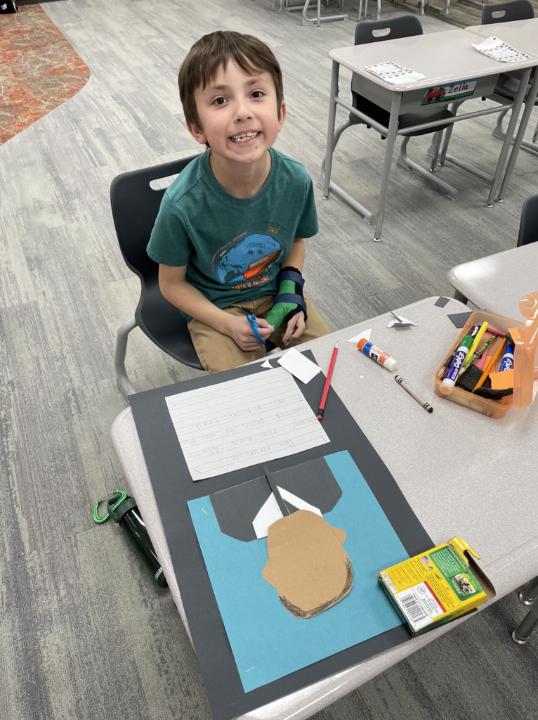 student showing their art during the process