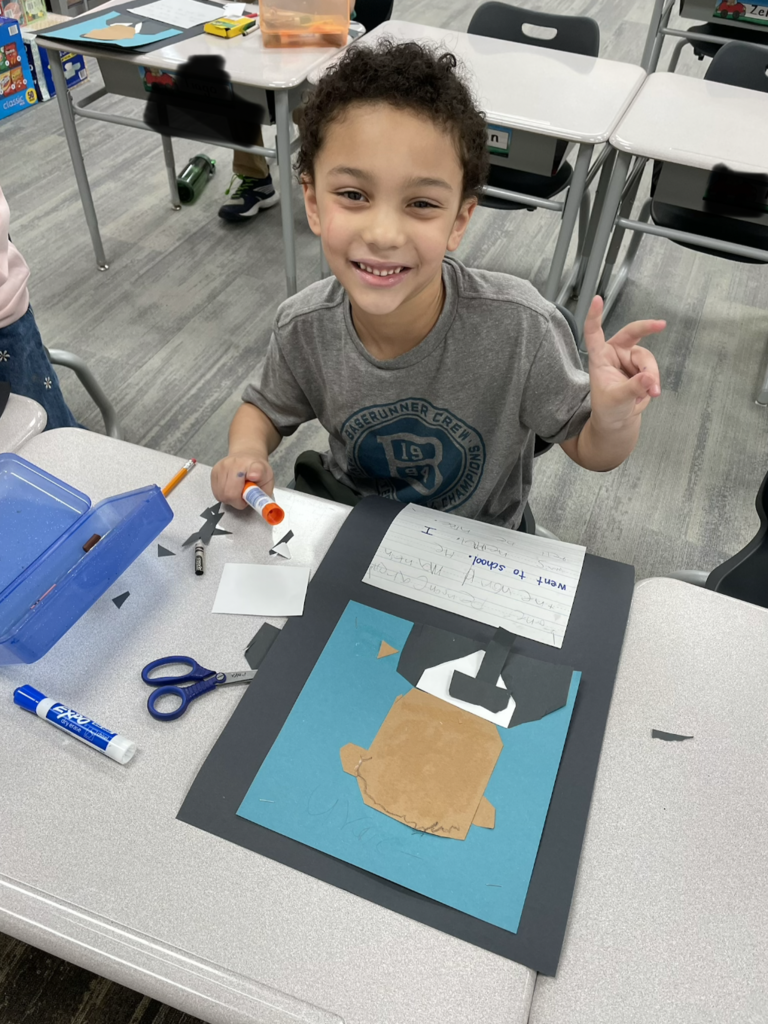 student showing their art during the process