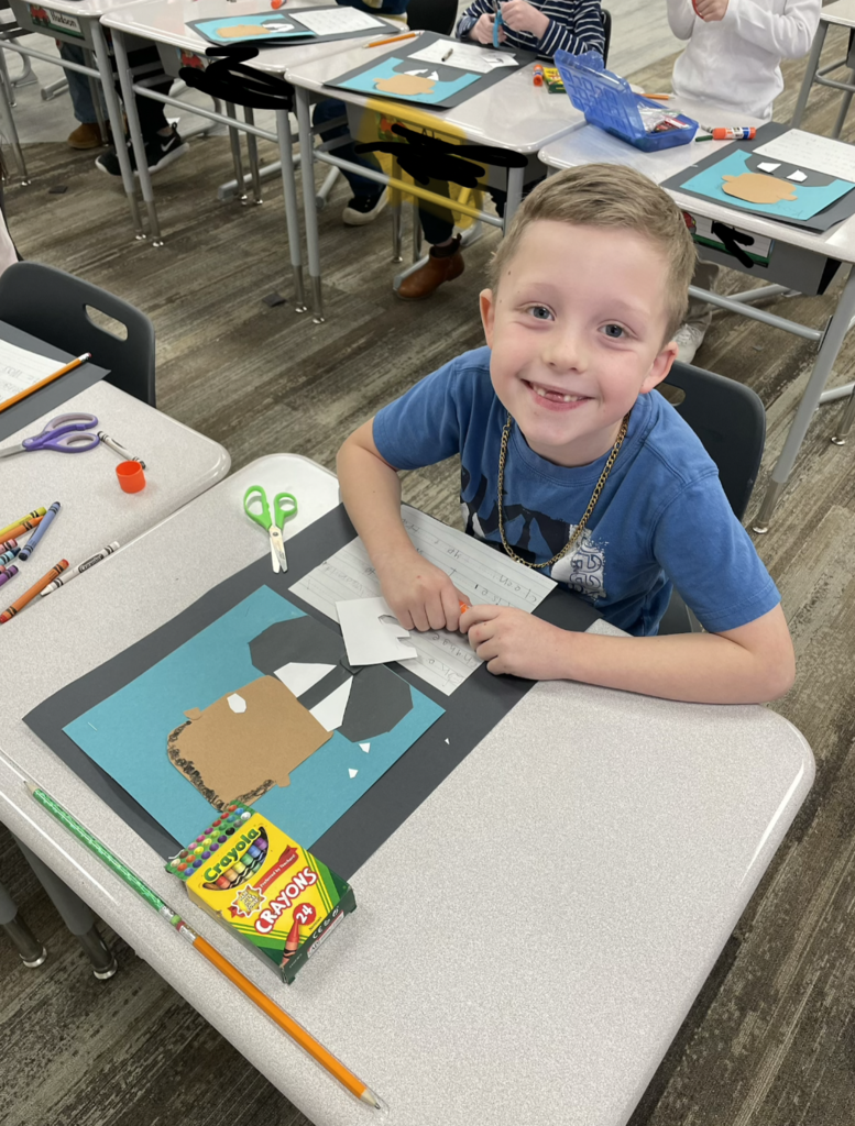 student showing their art during the process