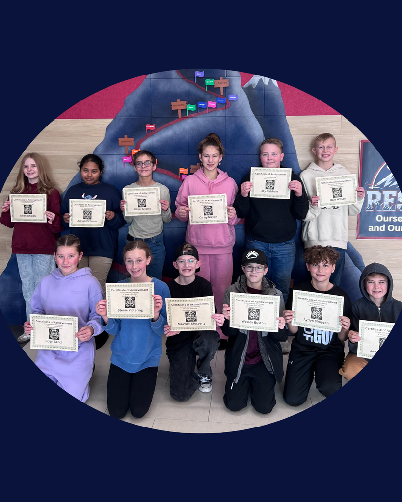 A large group photo of students arranged in rows, smiling and holding up academic certificates