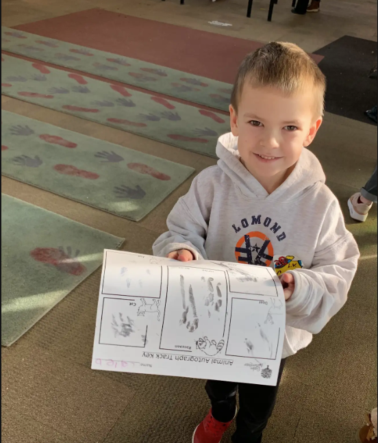 Student holding a piece of paper. 