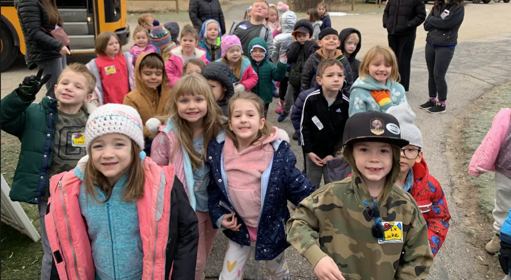 Group of kids getting off the bus for a field trip. 