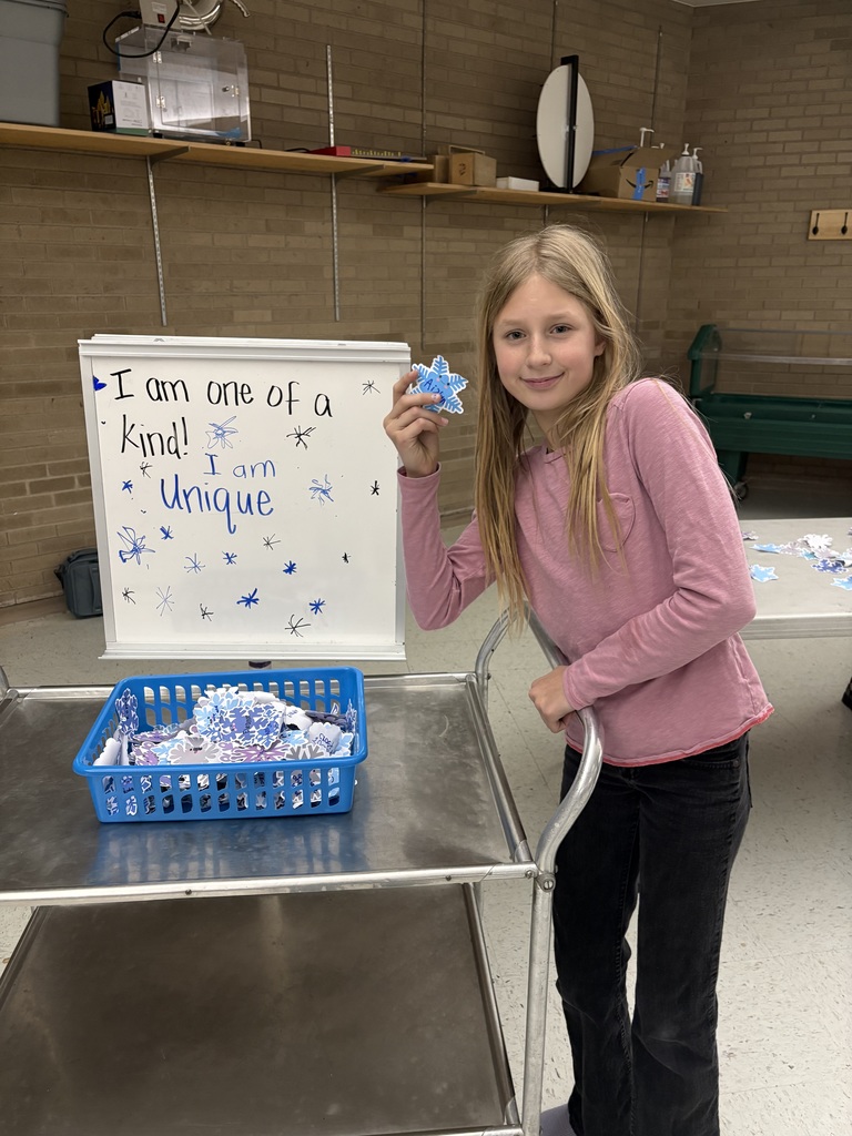 student holding snowflake