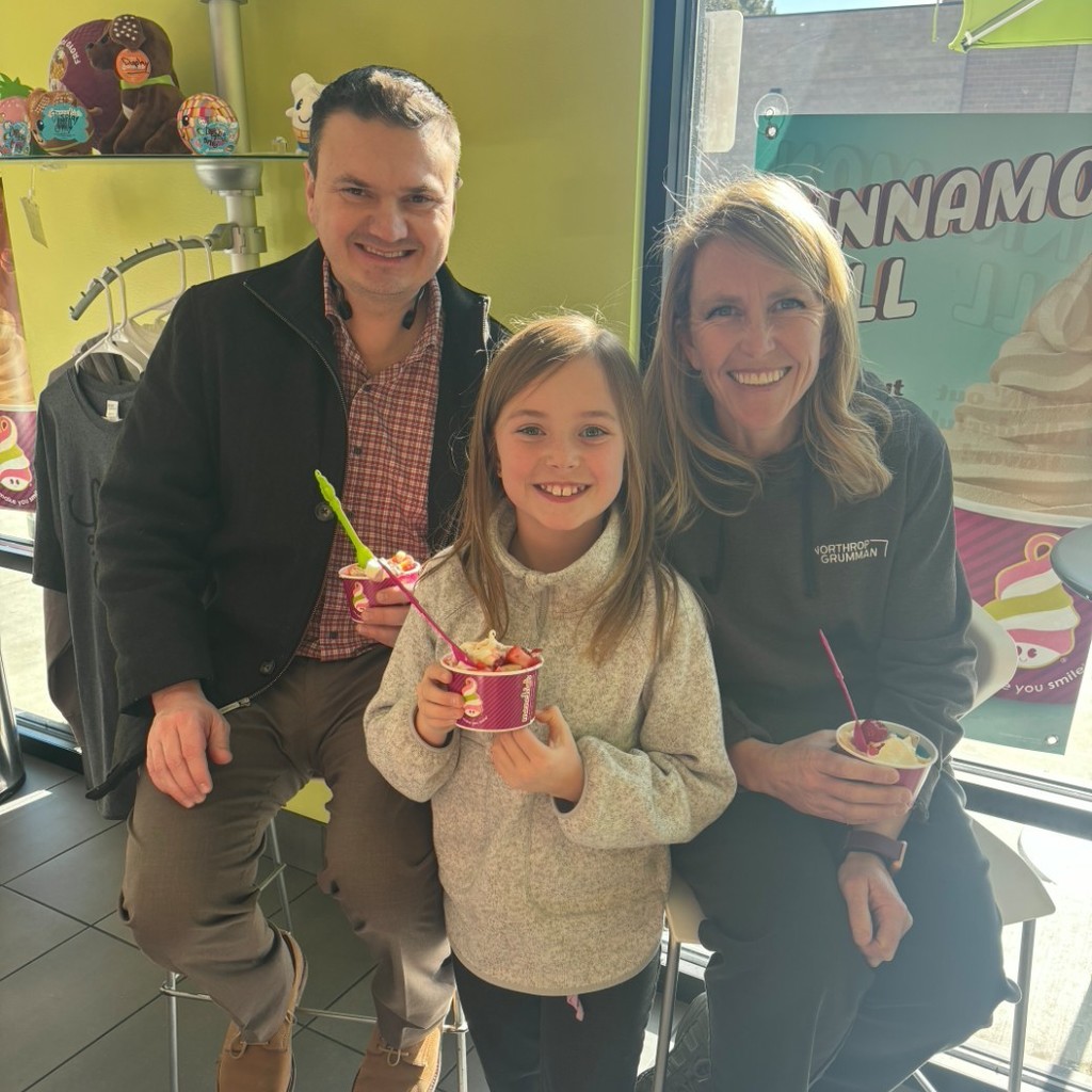Girl holding icecream with her parents at Menchies