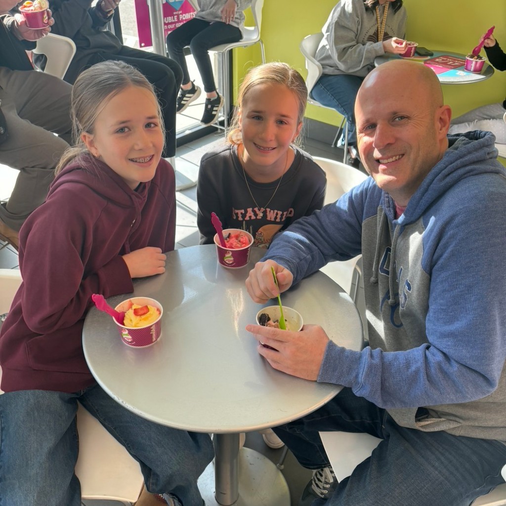Girls enjoying icecream with their dad at Menchies
