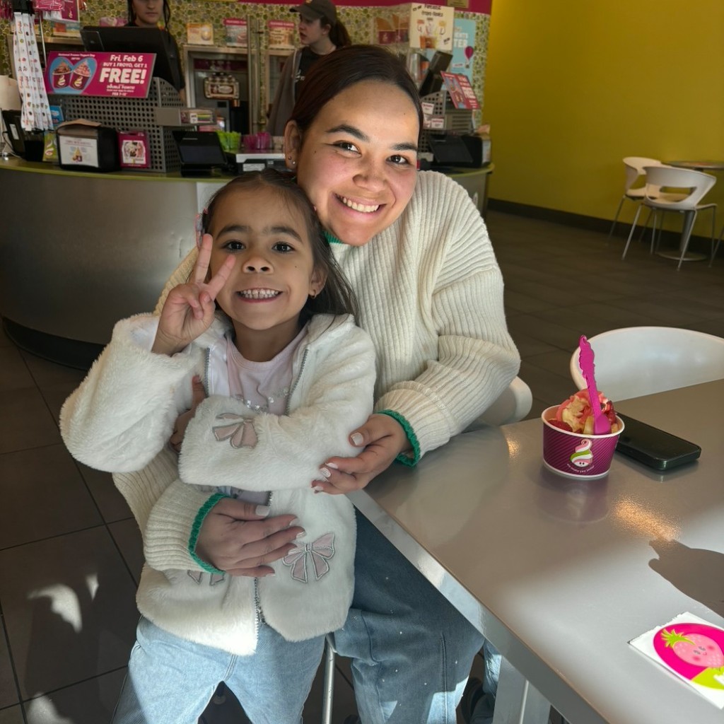 A girl and her mom eating icecream at Menchies. 