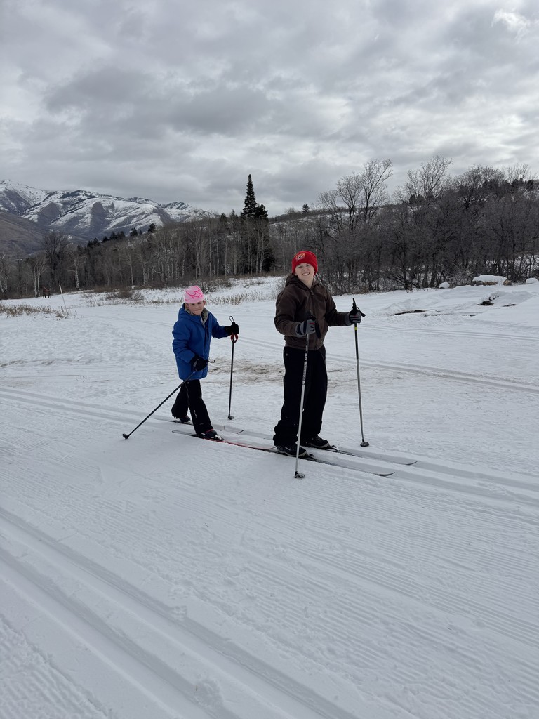 two kids cross country skiing