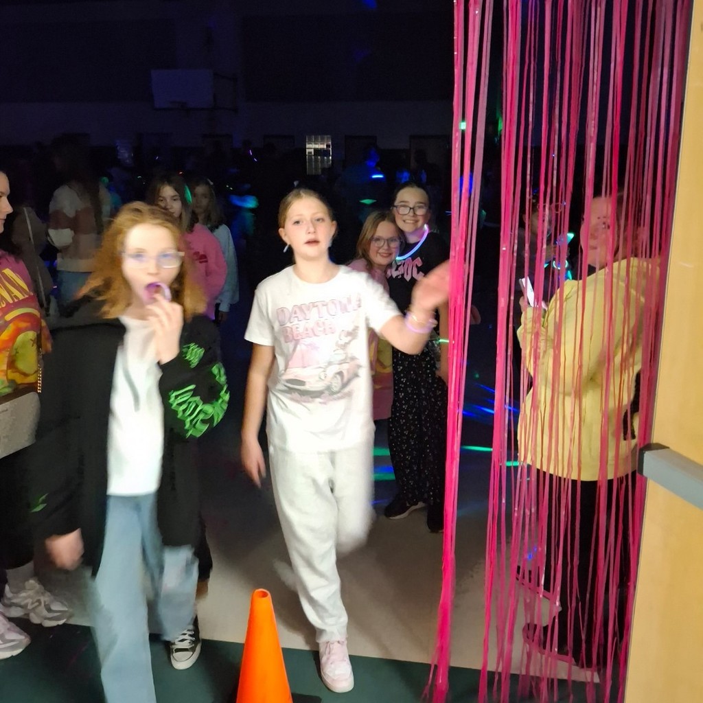 girls walking through the door with streamers