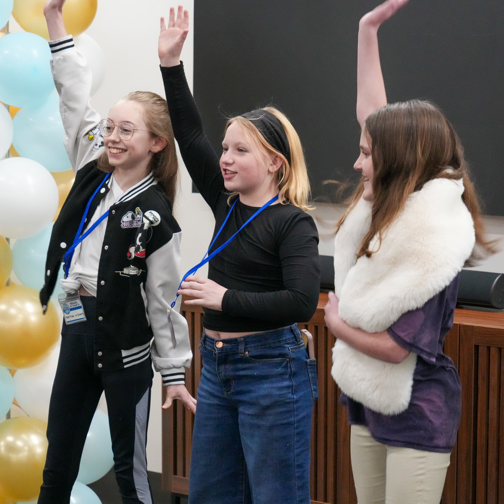 Students telling stories at a microphone.