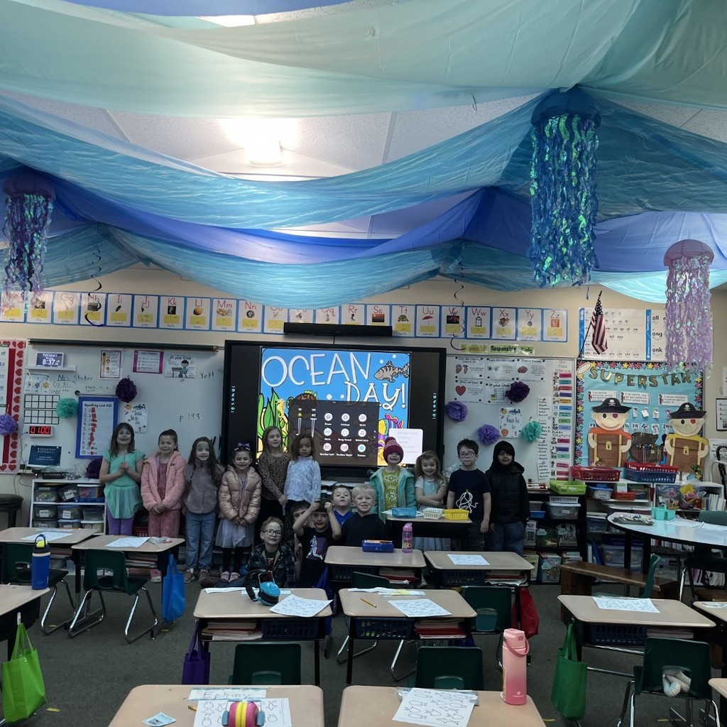 Mrs.  Stoker's class with blue banners hanging from the ceiling to look like waves