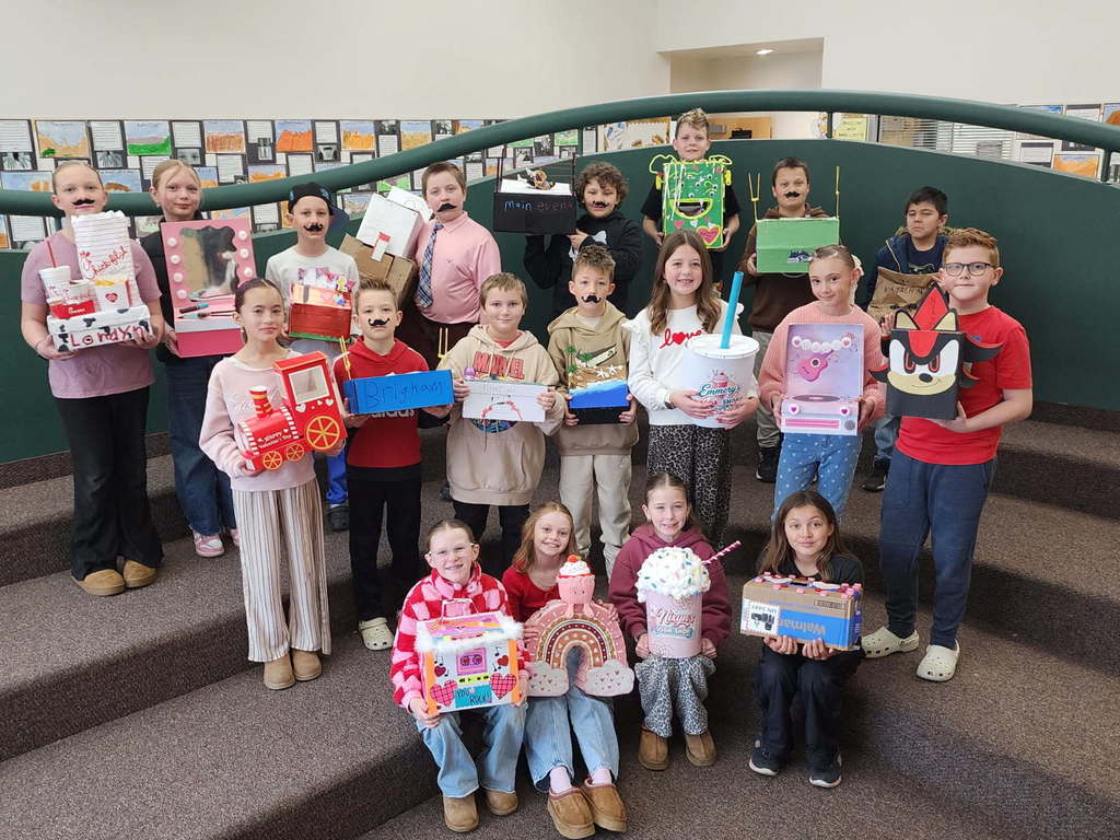 students smiling with valentines boxes