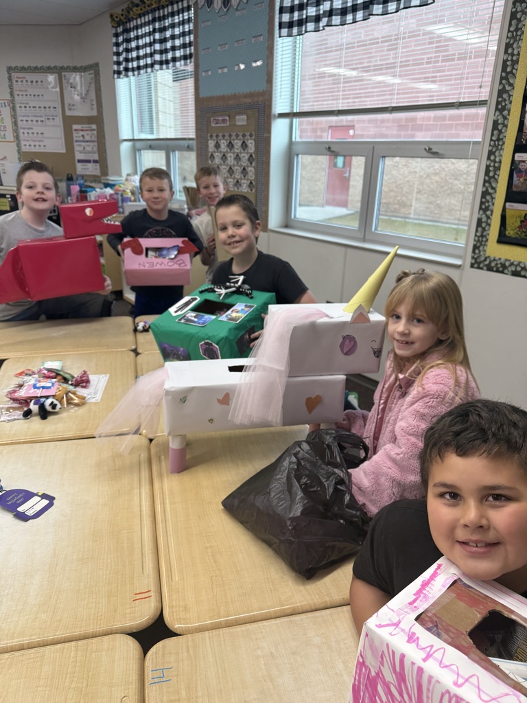 students smiling with valentine boxes