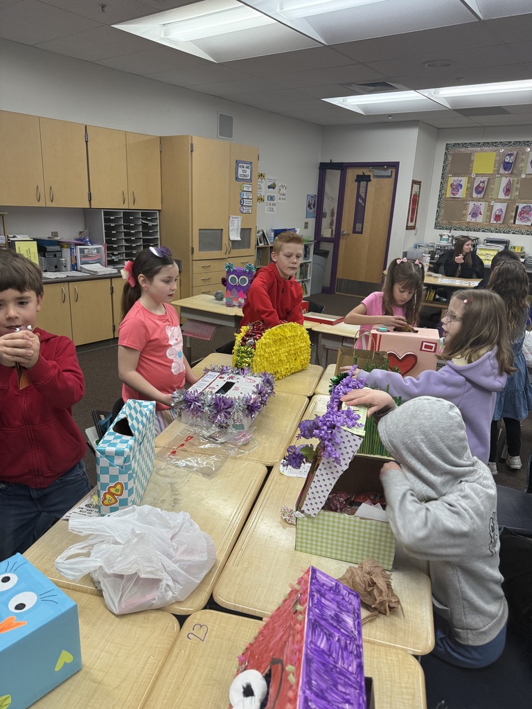 students smiling with valentine boxes