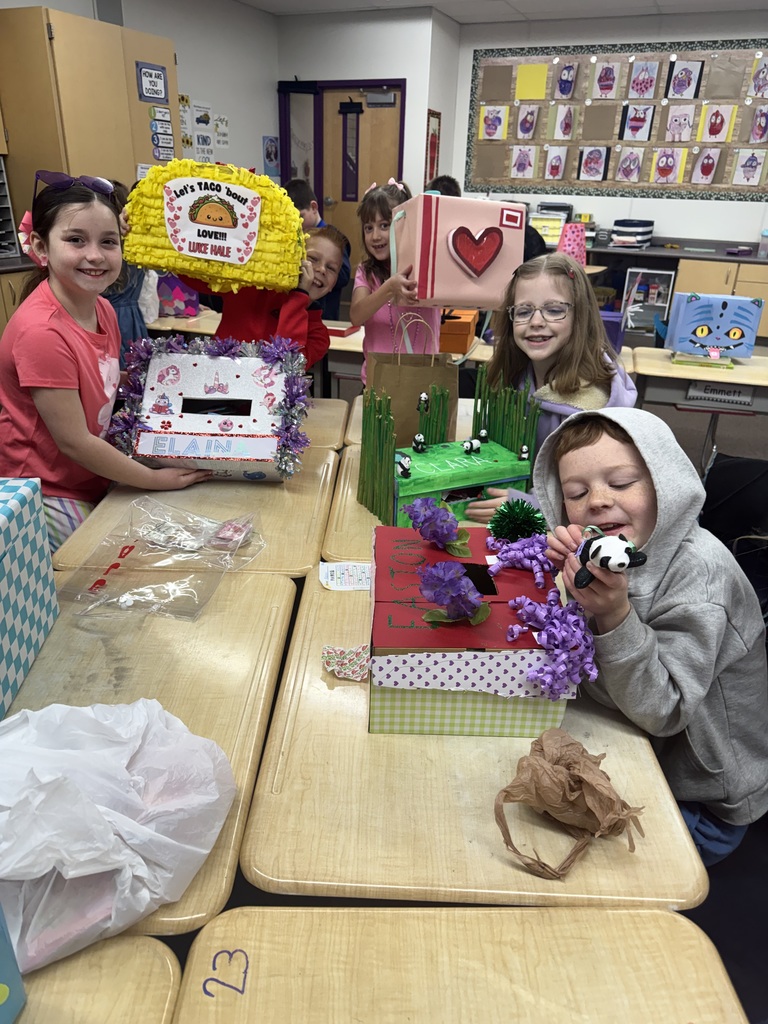 students smiling with valentine boxes