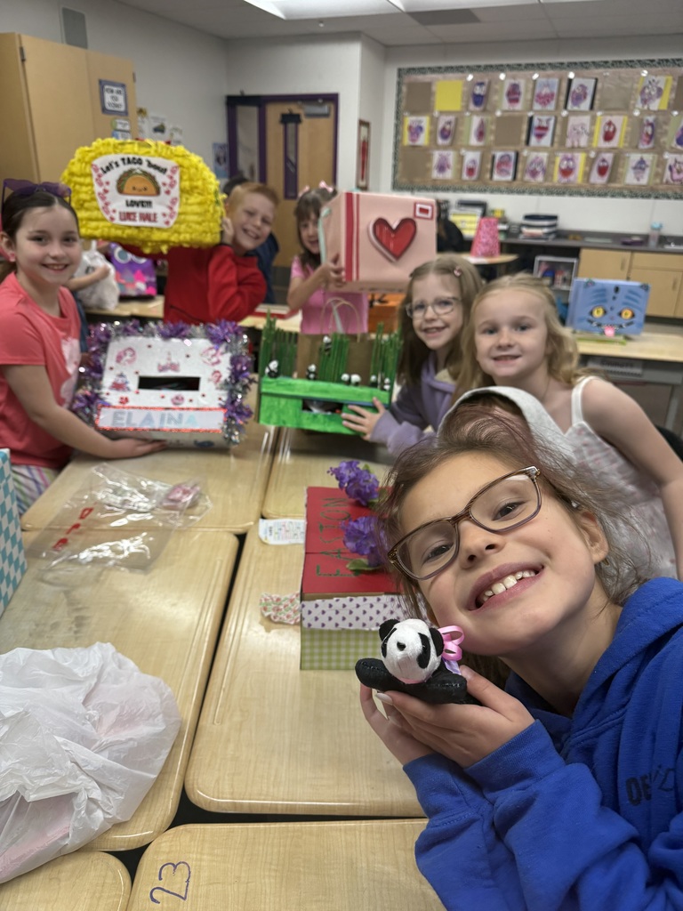 students smiling with valentine boxes